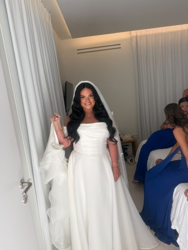 Smiling bride in full veil and A-line gown